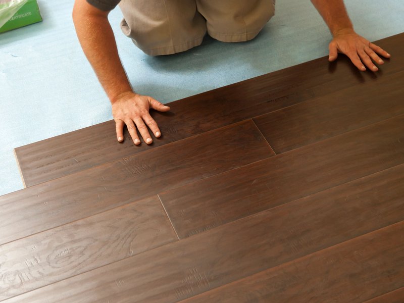 Person installing hardwood flooring from Korfhage Floor Covering in the Louisville, KY area